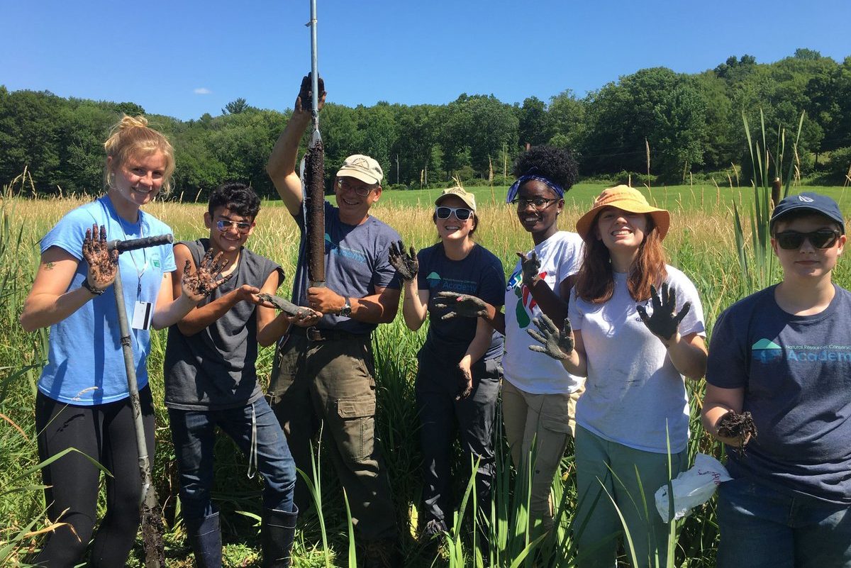 group of students with soil core samples